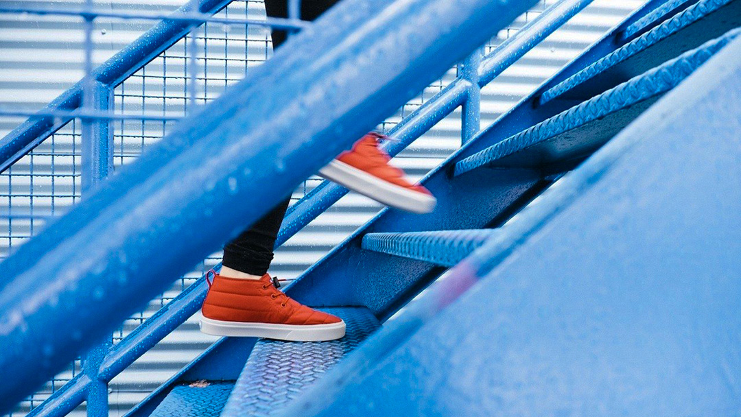 Turnschuhe erklimmen eine Treppe: als Symbol, dass Veränderungen mit Schwung gemeistert werden können